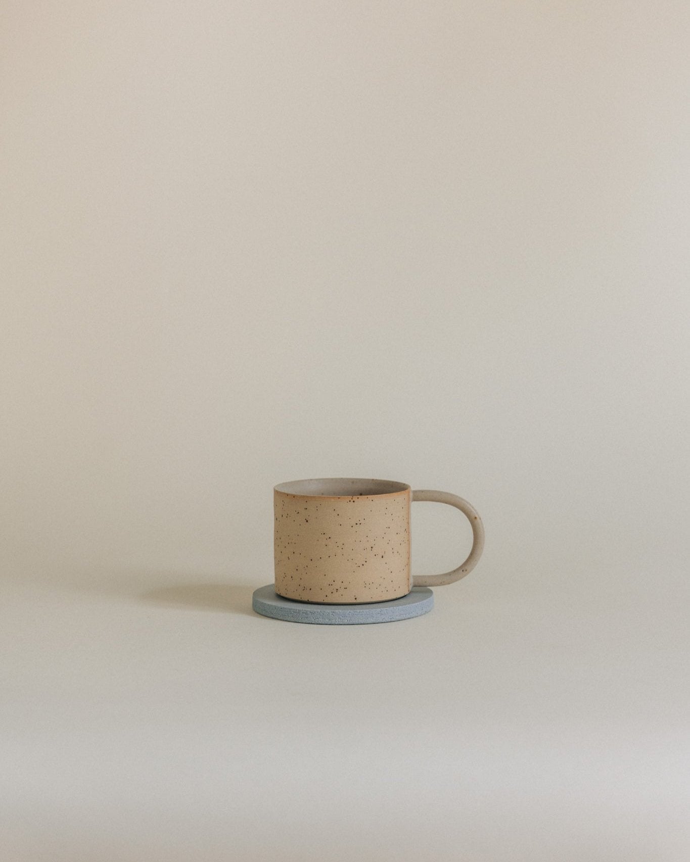 Simple mug in sand