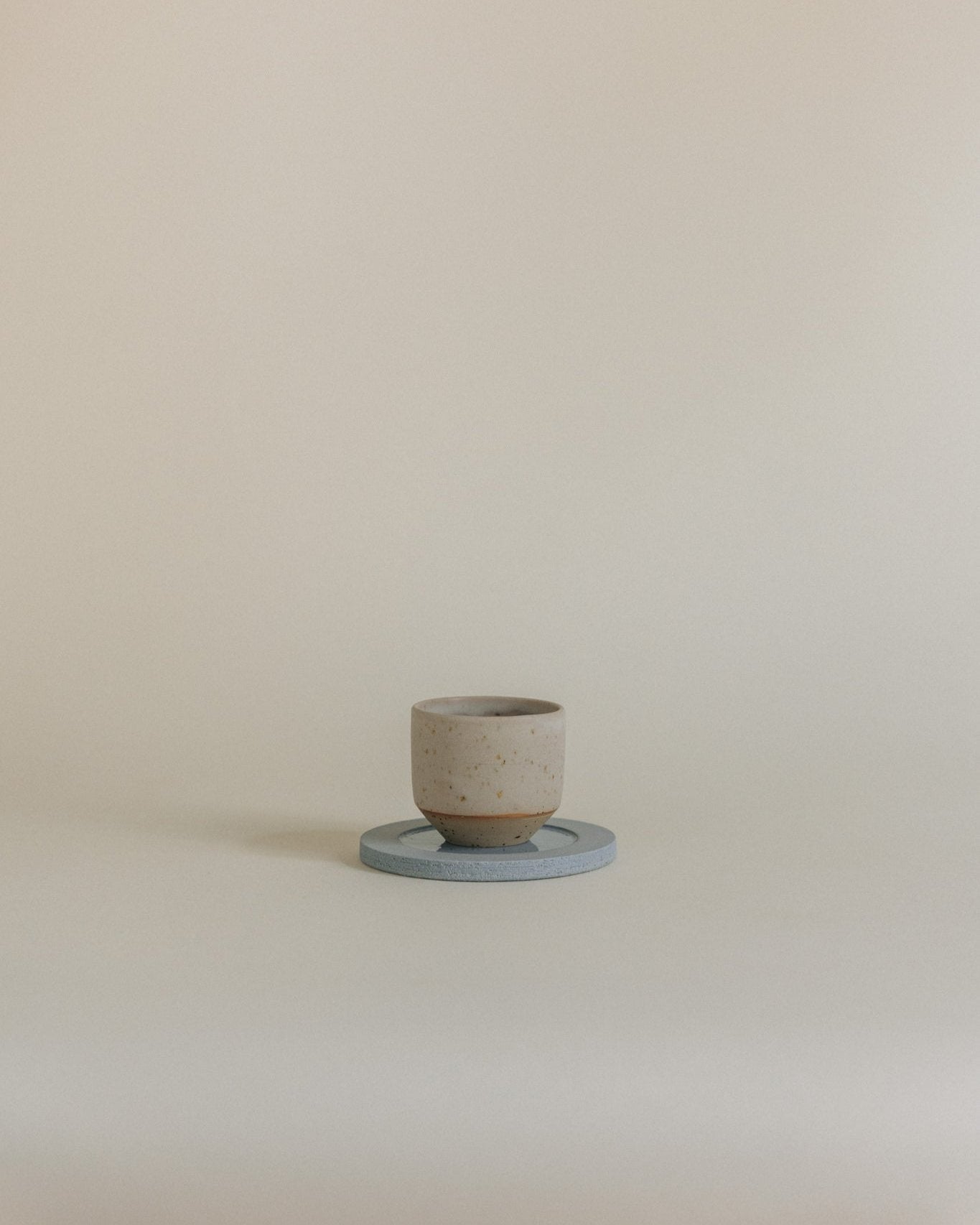 Espresso cup in sand