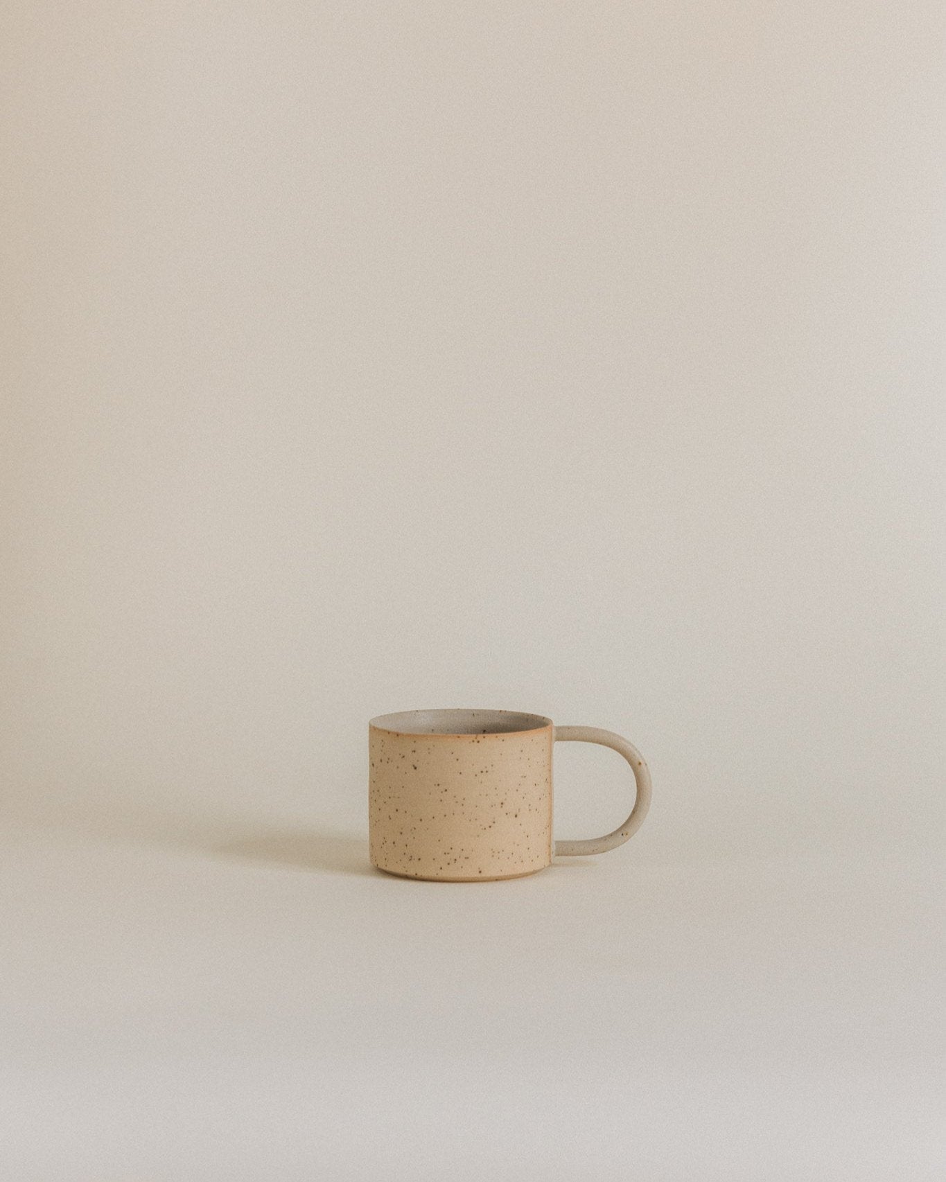 Simple mug in sand
