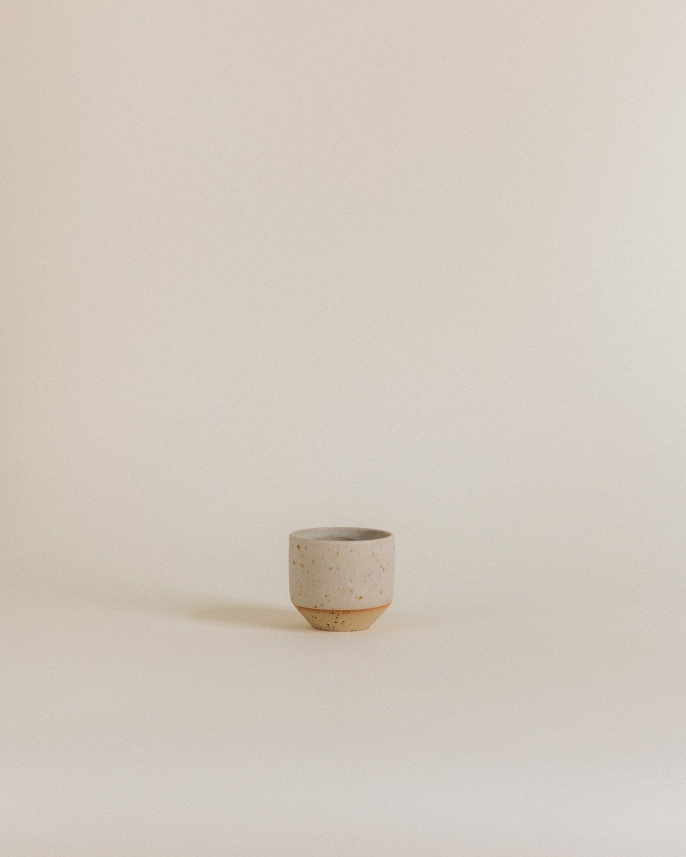 Espresso cup in sand