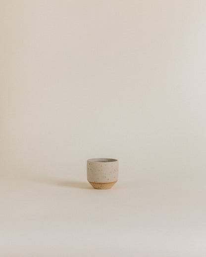 Espresso cup in sand